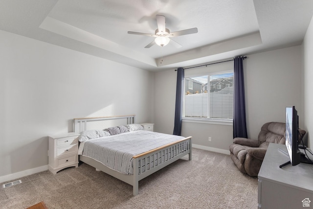 4142 N Fairfield Dr, Eagle Mountain, UT 84005 - bedroom with a tray ceiling, visible vents, a ceiling fan, light carpet, and baseboards