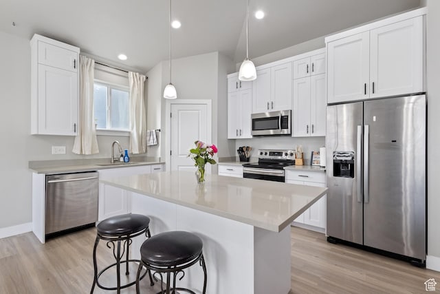 4142 N Fairfield Dr, Eagle Mountain, UT 84005 - kitchen with hanging light fixtures, stainless steel appliances, light countertops, white cabinetry, and a sink