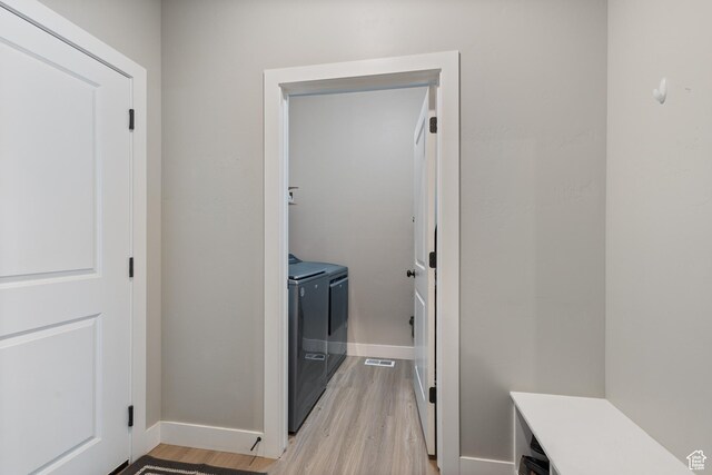 4142 N Fairfield Dr, Eagle Mountain, UT 84005 - washroom featuring light wood-type flooring, washing machine and dryer, laundry area, and baseboards