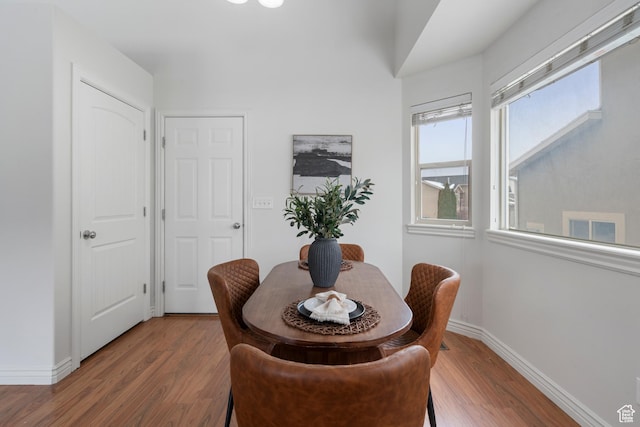 dining room with baseboards and wood finished floors