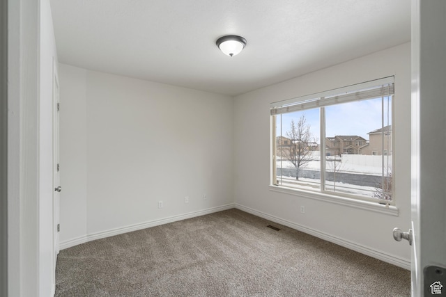 spare room with carpet floors and baseboards