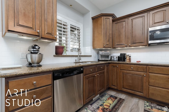 3013 W Alta Peak Rd, South Jordan, UT 84095 - kitchen with appliances with stainless steel finishes, stone countertops, a sink, and backsplash