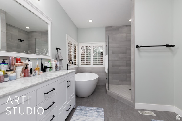 3013 W Alta Peak Rd, South Jordan, UT 84095 - full bathroom with a freestanding tub, vanity, baseboards, visible vents, and a shower stall