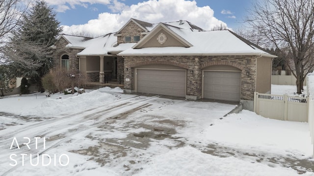 3013 W Alta Peak Rd, South Jordan, UT 84095 - view of front of home with a garage, stone siding, fence, and stucco siding