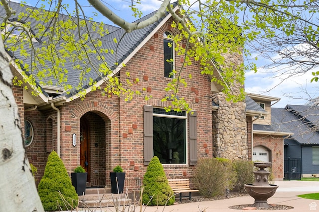 1609 E Quail Way, Logan, UT 84321 - tudor home with brick siding and a shingled roof