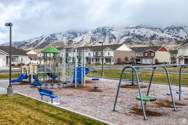 community playground featuring a residential view, a mountain view, and a lawn