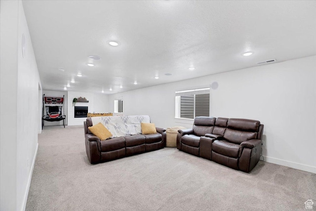 living area with recessed lighting, baseboards, carpet, and a fireplace