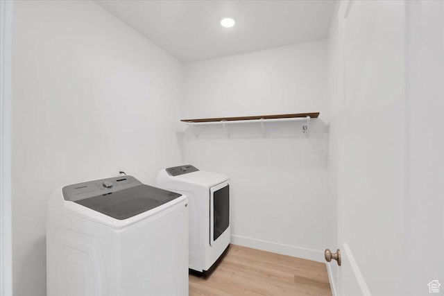 laundry room with laundry area, recessed lighting, baseboards, light wood-type flooring, and washer and clothes dryer
