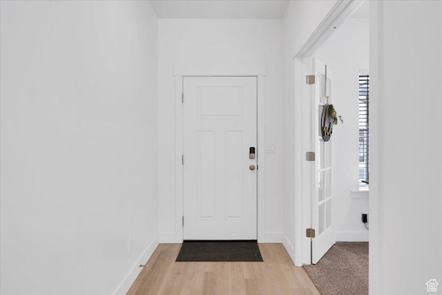 interior space featuring baseboards and light wood-type flooring