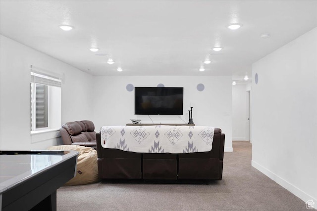 living room featuring baseboards, recessed lighting, and light colored carpet
