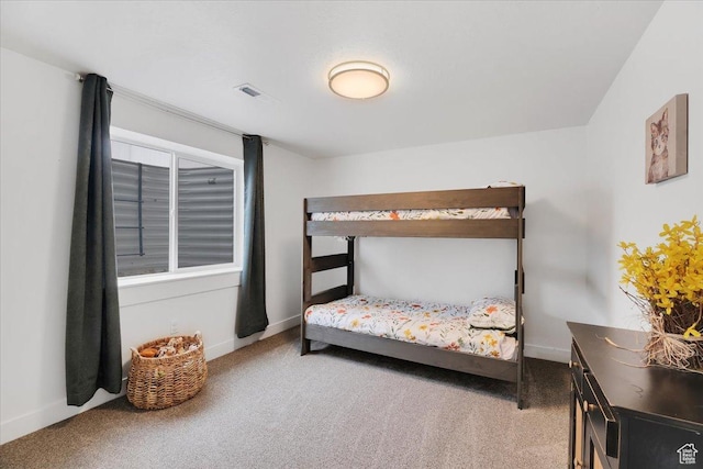 carpeted bedroom with baseboards and visible vents