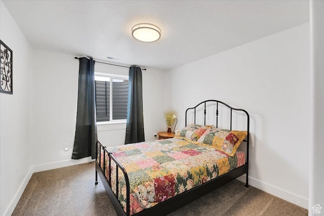 bedroom featuring baseboards, carpet flooring, and visible vents