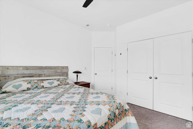 carpeted bedroom with a ceiling fan and a closet