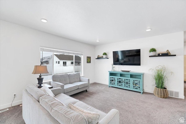carpeted living area featuring recessed lighting, baseboards, and visible vents