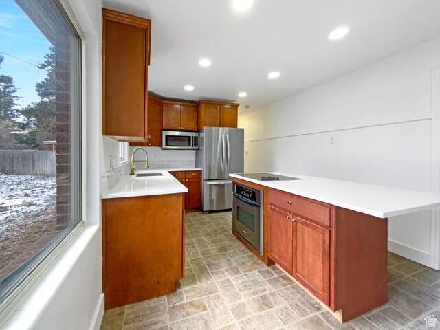 2943 S 400 W, Bountiful, UT 84010 - kitchen with appliances with stainless steel finishes, a center island, light countertops, and a sink