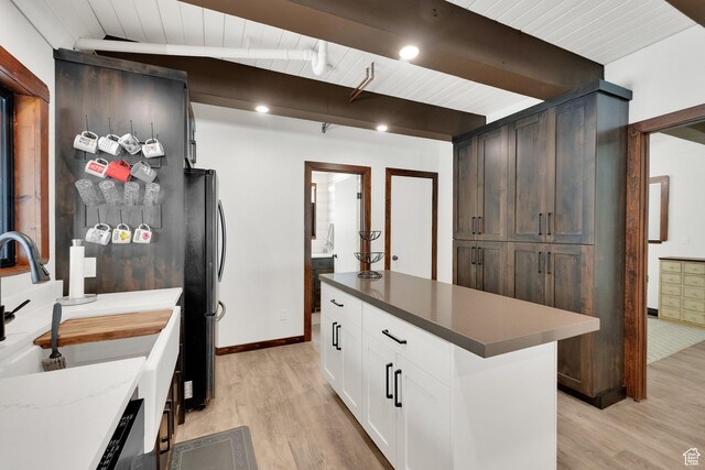 11249 E Columbine Ln Unit 1607, Heber City, UT 84032 - kitchen featuring light wood-type flooring, a sink, white cabinetry, freestanding refrigerator, and wooden ceiling with exposed beams