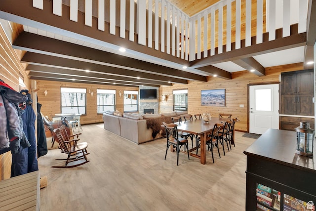 11249 E Columbine Ln Unit 1607, Heber City, UT 84032 - dining space featuring wooden walls, a stone fireplace, beamed ceiling, wood finished floors, and healthy amount of natural light