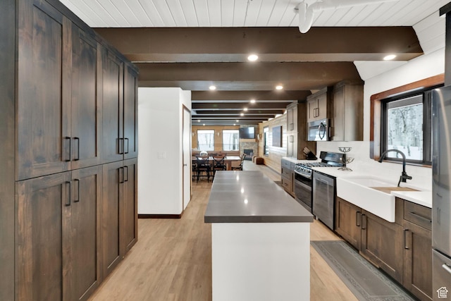 11249 E Columbine Ln Unit 1607, Heber City, UT 84032 - kitchen featuring appliances with stainless steel finishes, beam ceiling, a kitchen island, light wood finished floors, and a sink