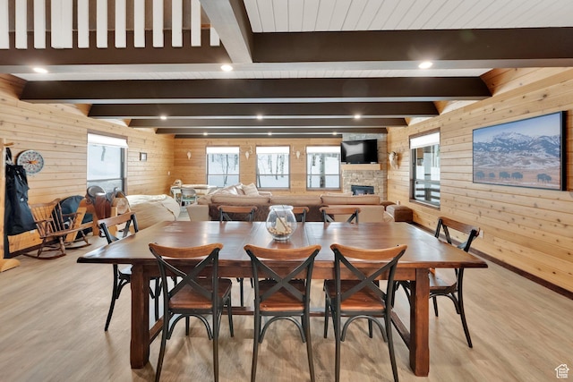 11249 E Columbine Ln Unit 1607, Heber City, UT 84032 - dining area with wooden walls, beamed ceiling, light wood finished floors, and a stone fireplace