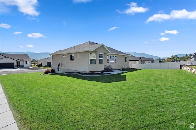 912 N 600 E, Morgan, UT 84050 - exterior space featuring stucco siding, a lawn, a mountain view, fence, and a residential view