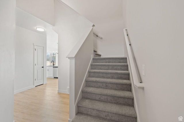 stairs featuring baseboards and wood finished floors
