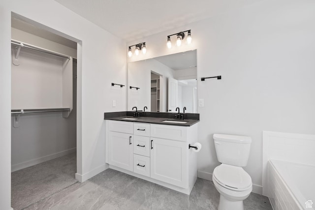 full bath with a walk in closet, a sink, toilet, and double vanity