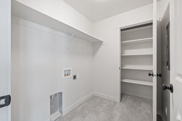laundry area with laundry area, baseboards, a textured ceiling, washer hookup, and electric dryer hookup