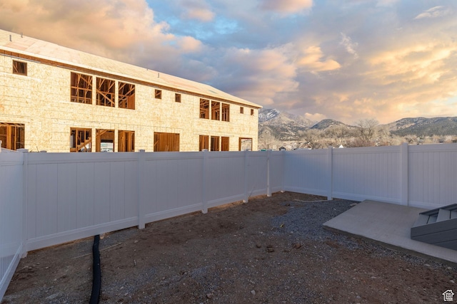 view of yard with a fenced backyard and a mountain view