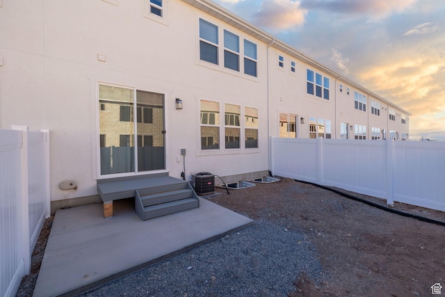 back of property featuring fence, a patio, and stucco siding