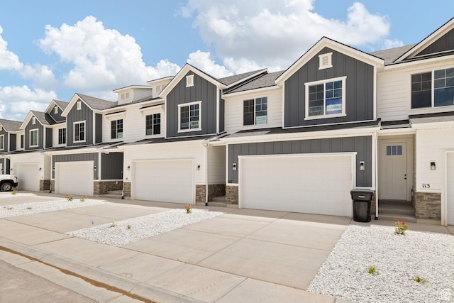 101 W 1360 N, Nephi, UT 84648 - townhome / multi-family property with board and batten siding, a garage, stone siding, and driveway