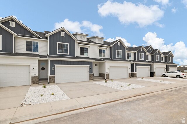 101 W 1360 N, Nephi, UT 84648 - townhome / multi-family property with board and batten siding, stone siding, a garage, and a residential view