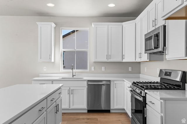 2571 N 3200 W, Clinton, UT 84015 - kitchen featuring stainless steel appliances, recessed lighting, a sink, white cabinetry, and light countertops
