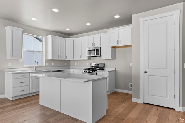 2571 N 3200 W, Clinton, UT 84015 - kitchen with appliances with stainless steel finishes, a sink, baseboards, light wood finished floors, and recessed lighting