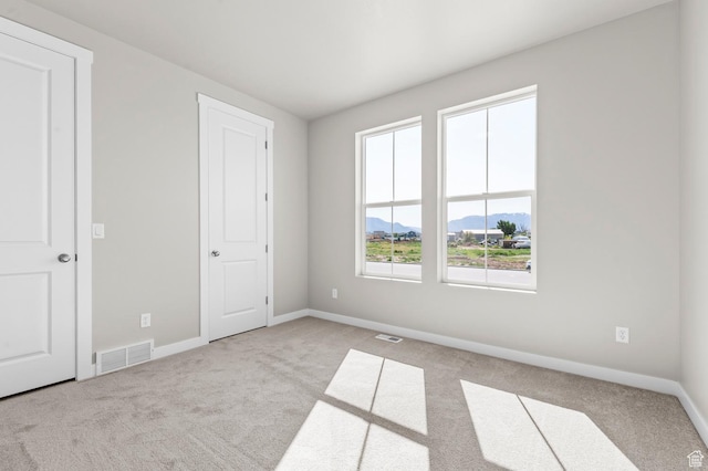 2571 N 3200 W, Clinton, UT 84015 - unfurnished bedroom featuring carpet, a mountain view, and baseboards