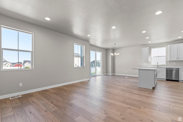 2571 N 3200 W, Clinton, UT 84015 - unfurnished living room with a chandelier, baseboards, recessed lighting, and light wood-style floors