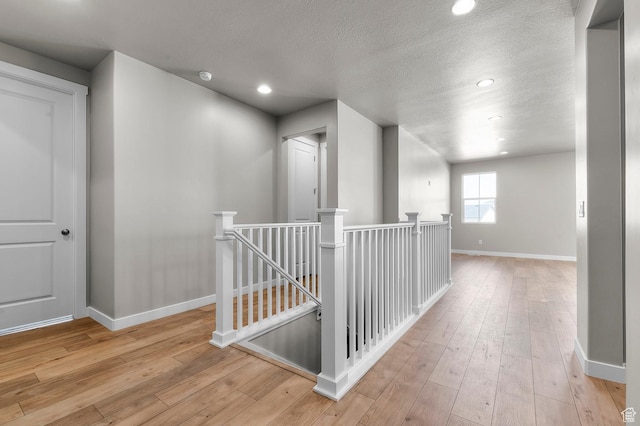 2571 N 3200 W, Clinton, UT 84015 - hallway featuring an upstairs landing, baseboards, hardwood / wood-style flooring, a textured ceiling, and recessed lighting