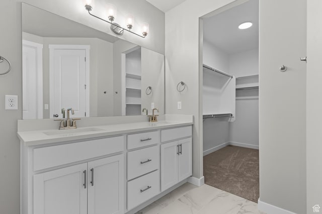 2571 N 3200 W, Clinton, UT 84015 - bathroom with double vanity, baseboards, a walk in closet, and marble finish flooring