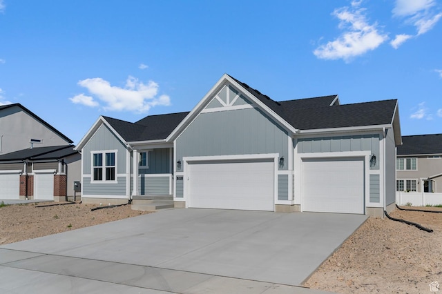 2571 N 3200 W, Clinton, UT 84015 - view of front of property featuring board and batten siding, an attached garage, concrete driveway, and a shingled roof