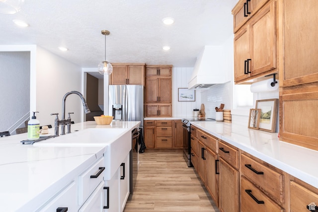 93 N 200 W, Smithfield, UT 84335 - kitchen featuring decorative light fixtures, stainless steel appliances, white cabinets, light stone countertops, and premium range hood