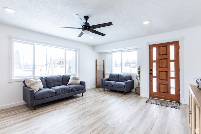 93 N 200 W, Smithfield, UT 84335 - living room with light wood-style flooring, baseboards, and a textured ceiling