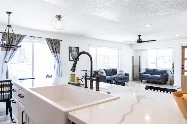 93 N 200 W, Smithfield, UT 84335 - kitchen with open floor plan, hanging light fixtures, a sink, and a healthy amount of sunlight
