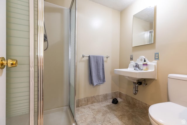 93 N 200 W, Smithfield, UT 84335 - bathroom featuring toilet, a stall shower, a sink, and tile patterned floors