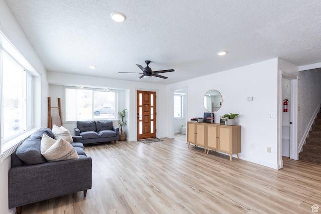 93 N 200 W, Smithfield, UT 84335 - living room featuring light wood finished floors, stairs, and a textured ceiling