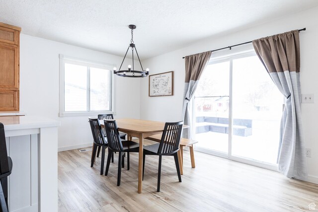 93 N 200 W, Smithfield, UT 84335 - dining area featuring baseboards, a notable chandelier, a textured ceiling, and light wood finished floors