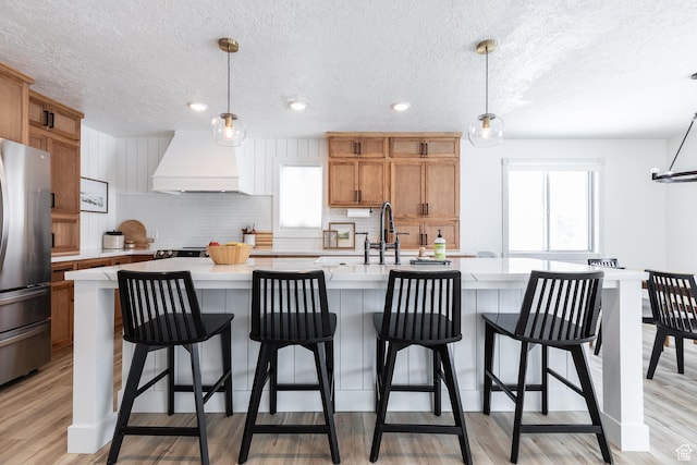93 N 200 W, Smithfield, UT 84335 - kitchen with premium range hood, freestanding refrigerator, light countertops, and decorative light fixtures