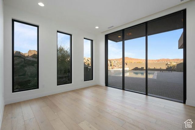 2655 W Shoshoni Trl, St George, UT 84770 - unfurnished room with light wood-style flooring, a mountain view, a wealth of natural light, and recessed lighting