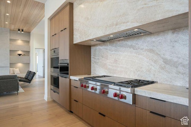 2655 W Shoshoni Trl, St George, UT 84770 - kitchen featuring light countertops, light wood-style flooring, decorative backsplash, appliances with stainless steel finishes, and open floor plan
