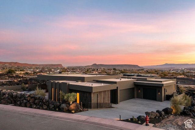 2655 W Shoshoni Trl, St George, UT 84770 - view of front facade featuring driveway, an attached garage, a mountain view, and stucco siding