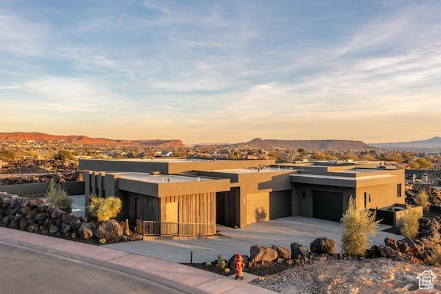 2655 W Shoshoni Trl, St George, UT 84770 - view of front facade featuring a garage, driveway, a mountain view, and stucco siding