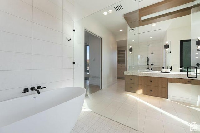 2655 W Shoshoni Trl, St George, UT 84770 - full bathroom featuring visible vents, a soaking tub, tile patterned flooring, vanity, and tile walls